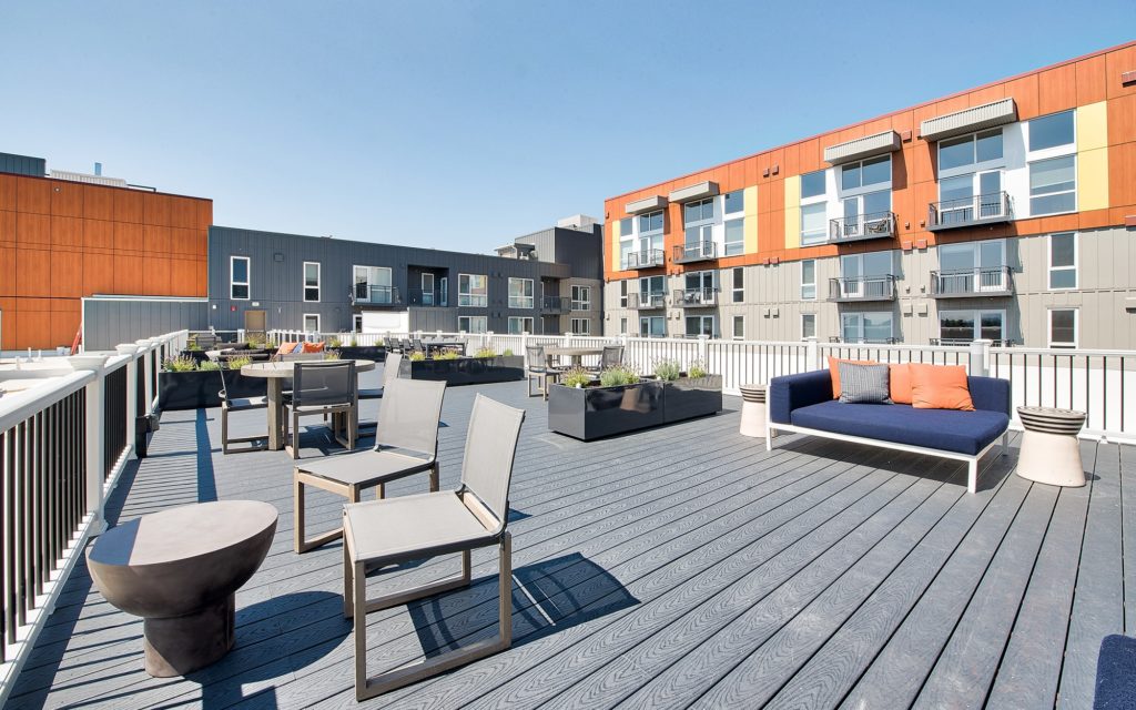 Rooftop amenity space with lounge seating and tables